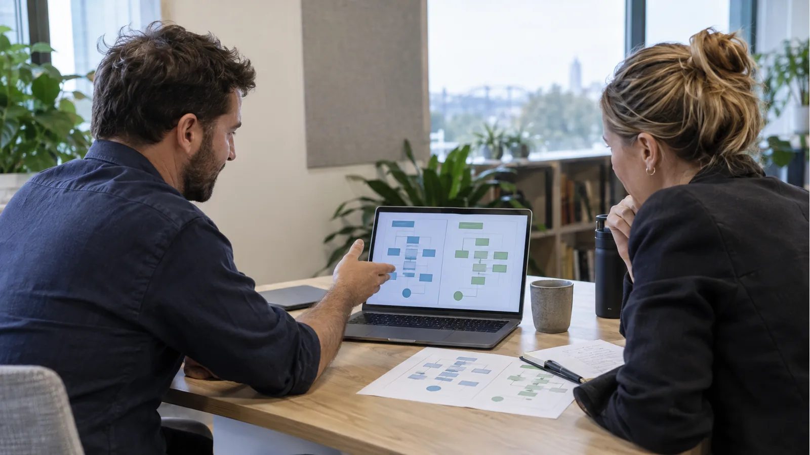 Product and operations leads comparing organisation-specific payment workflows on a laptop in an Australian office