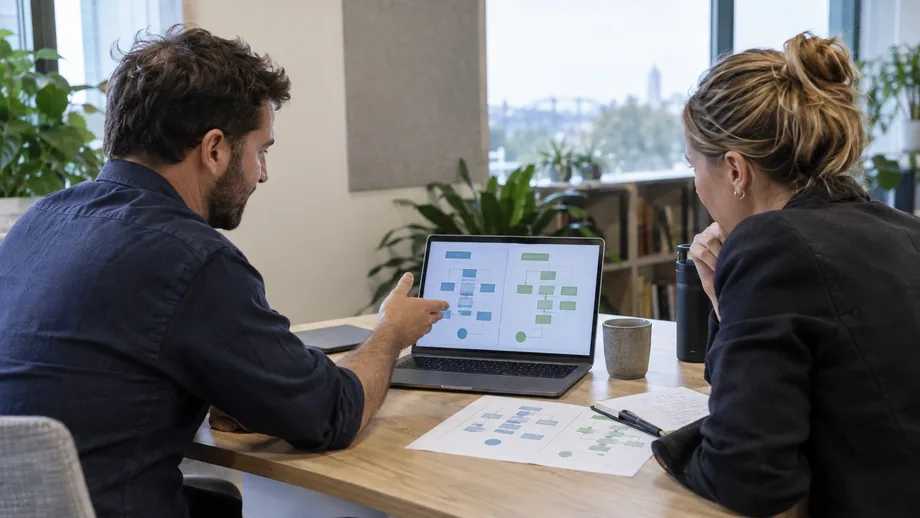 Product and operations leads comparing organisation-specific payment workflows on a laptop in an Australian office
